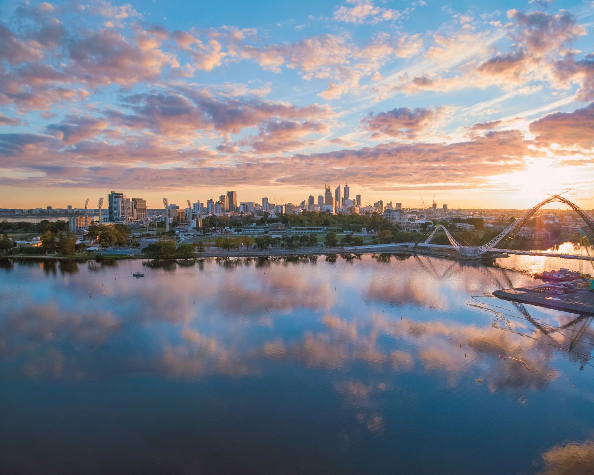 sunset over a bridge spanning the river