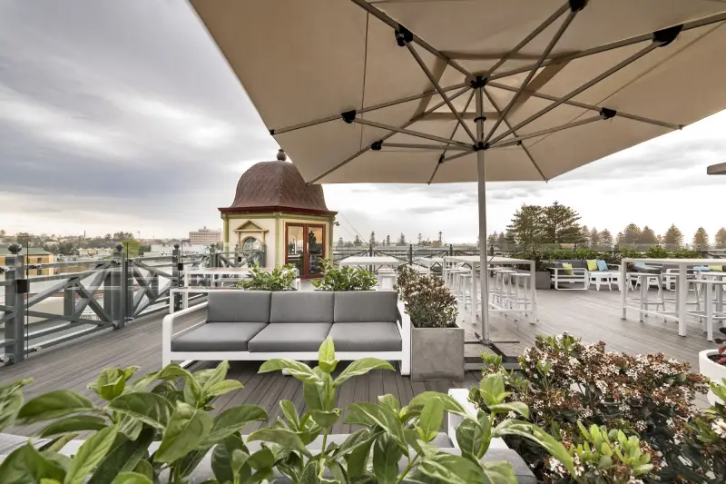 roof top bar with umbrella and sofas