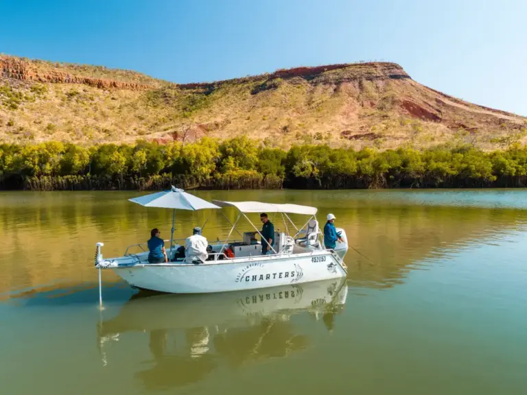 Best Kimberley Tours: Best Tours for First-Timers 3 small white boat cruising along the water